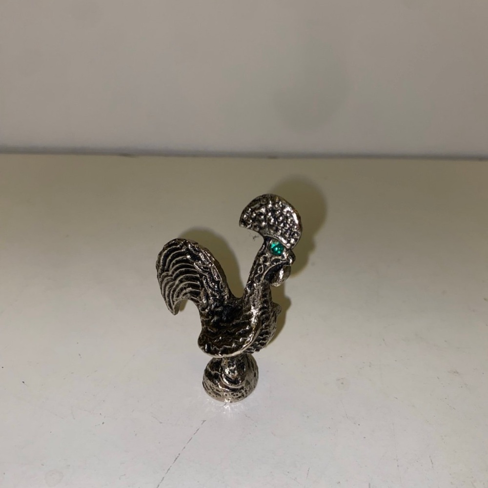 Vintage silver color rooster with green eyes 
Decor
